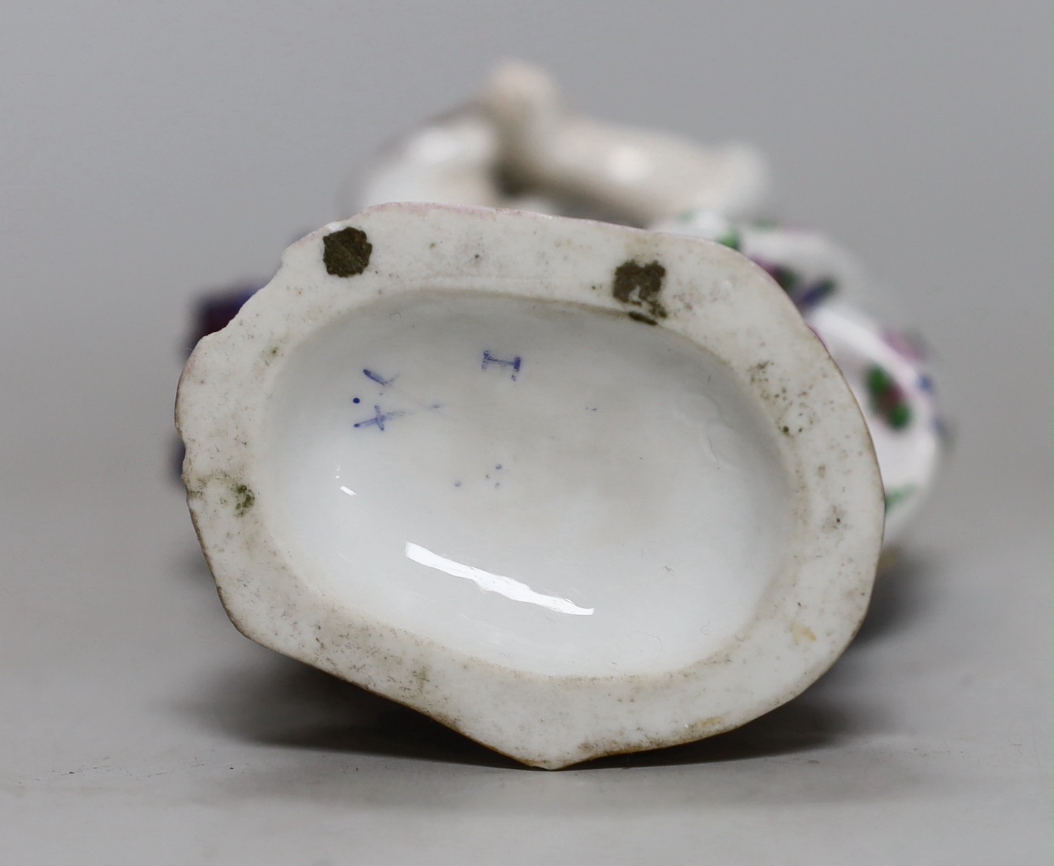 An American cast iron novelty 'John Bull' timepiece and a porcelain group